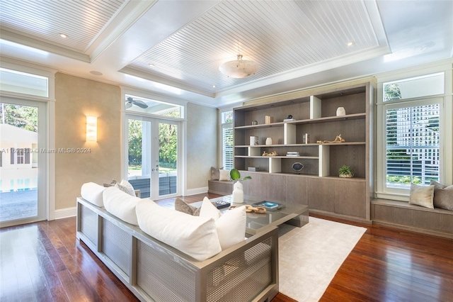 living room with plenty of natural light, dark hardwood / wood-style flooring, ornamental molding, and french doors