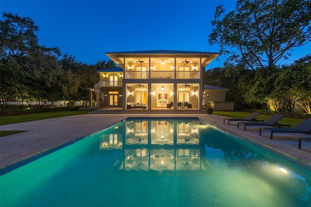 view of swimming pool featuring a patio area and ceiling fan