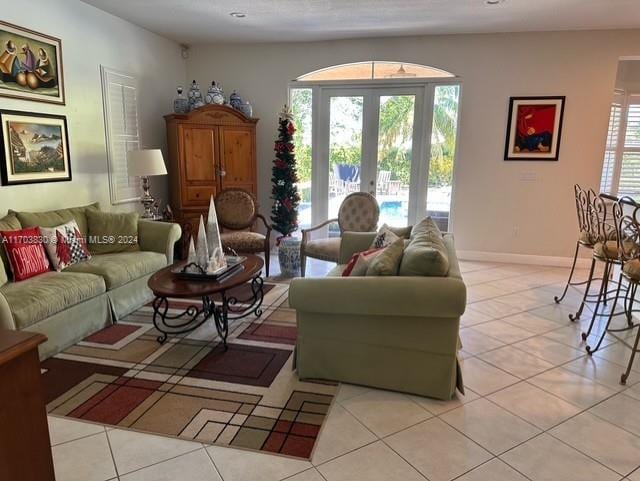 tiled living room featuring french doors