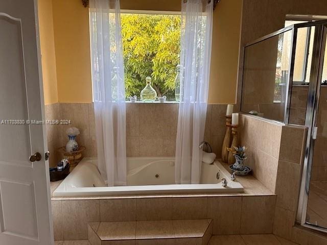 bathroom with tile patterned floors, plenty of natural light, and plus walk in shower