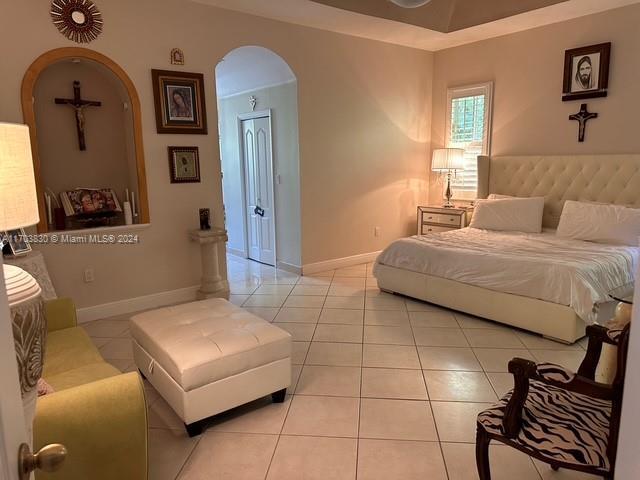 bedroom featuring light tile patterned flooring