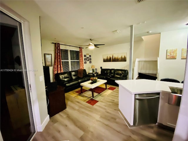 living room featuring light hardwood / wood-style flooring and ceiling fan