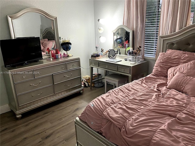 bedroom with dark wood-type flooring