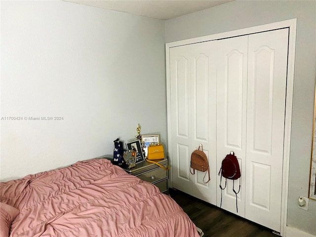 bedroom with a closet and dark hardwood / wood-style flooring