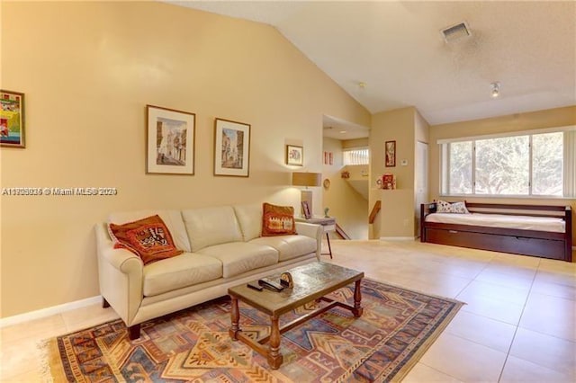 living room featuring high vaulted ceiling and light tile patterned flooring