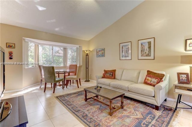 living room featuring high vaulted ceiling and light tile patterned flooring