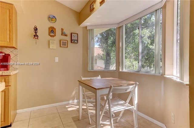 dining space featuring light tile patterned floors and plenty of natural light