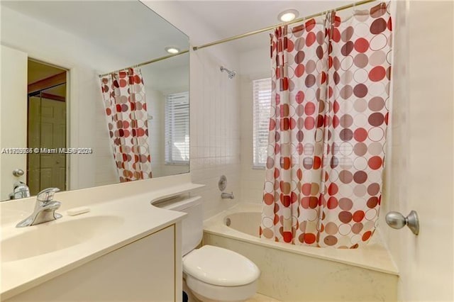 full bathroom with vanity, toilet, and shower / bath combo with shower curtain