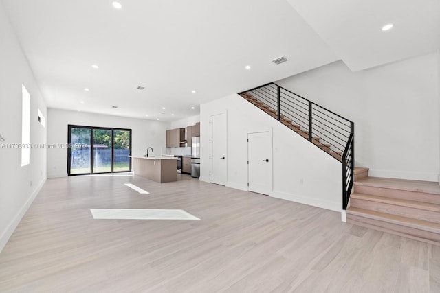 unfurnished living room featuring light hardwood / wood-style flooring