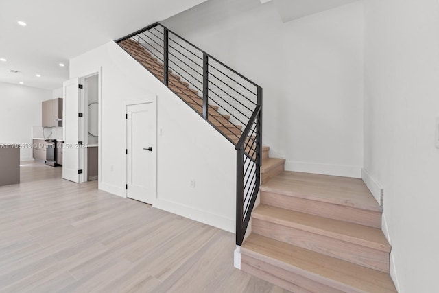 staircase featuring wood-type flooring