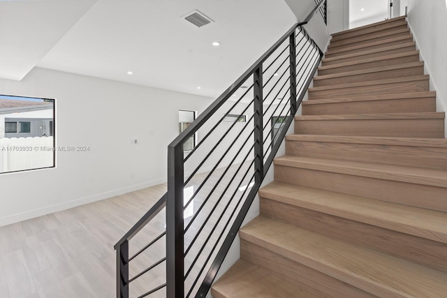 stairs with wood-type flooring