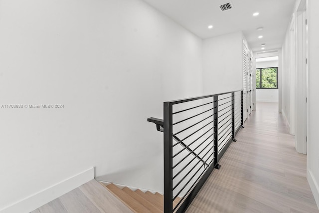 staircase with hardwood / wood-style floors