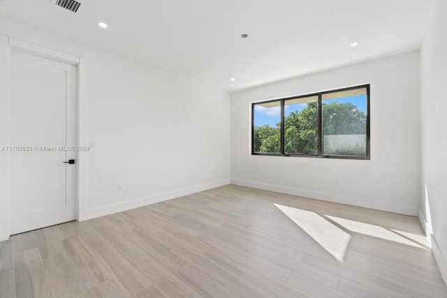 empty room with light hardwood / wood-style flooring