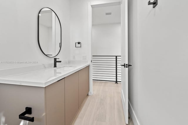 bathroom with hardwood / wood-style floors and vanity