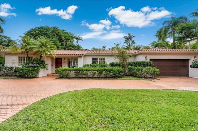 ranch-style home featuring a front yard and a garage