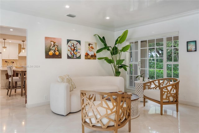 living area with light tile patterned floors and crown molding