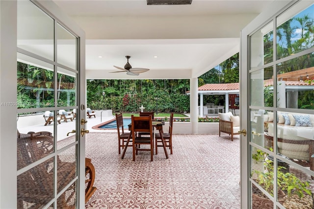 sunroom featuring french doors and ceiling fan