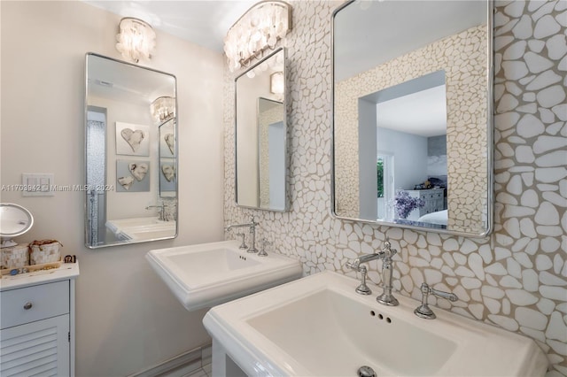 bathroom featuring vanity and tasteful backsplash