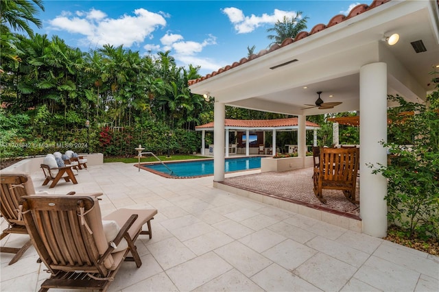 view of pool featuring ceiling fan and a patio