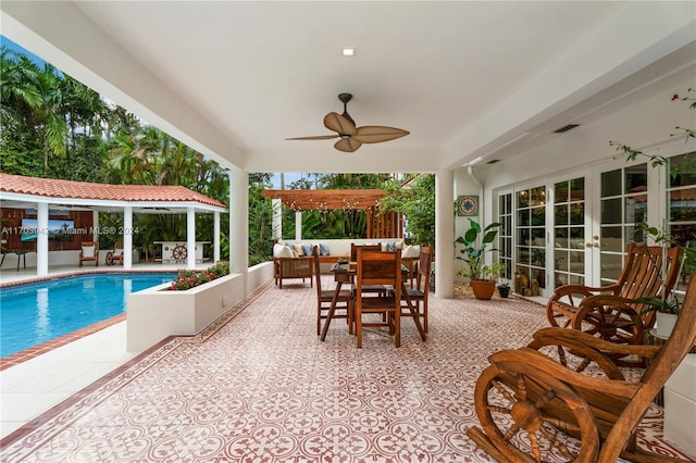 view of pool with outdoor lounge area, ceiling fan, a patio, and french doors