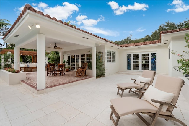 rear view of house featuring ceiling fan, french doors, and a patio