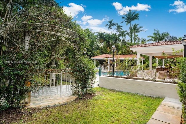 view of yard with a fenced in pool