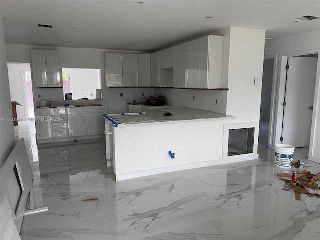 kitchen featuring white cabinetry and kitchen peninsula