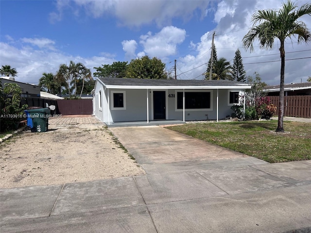 single story home with a front yard, fence, and stucco siding