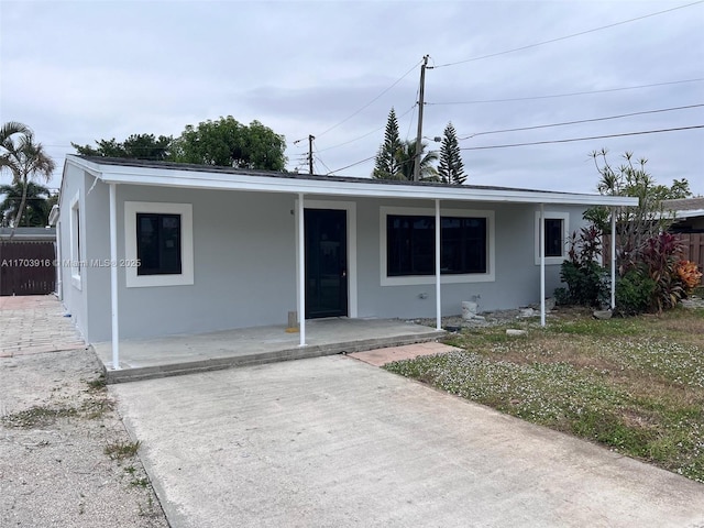 view of front of property with fence and stucco siding