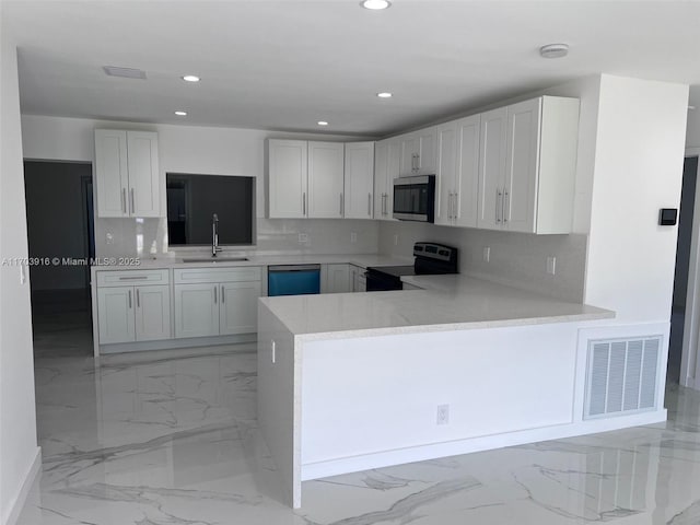 kitchen featuring visible vents, stainless steel microwave, electric range, a sink, and dishwasher