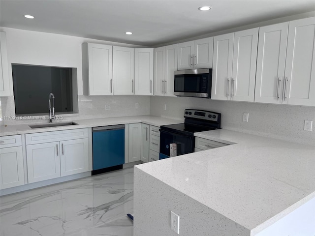 kitchen with electric stove, marble finish floor, stainless steel microwave, a sink, and dishwashing machine