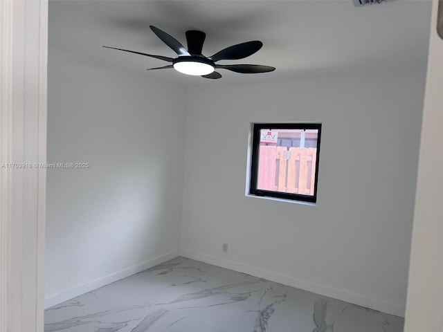 empty room featuring visible vents, marble finish floor, a ceiling fan, and baseboards