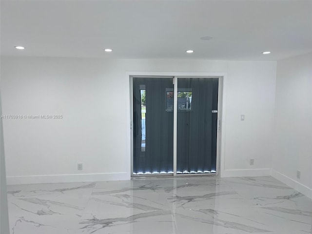 empty room with marble finish floor, baseboards, and recessed lighting