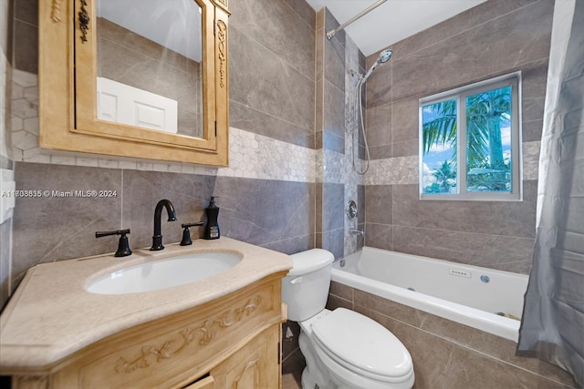 full bathroom with shower / tub combo, vanity, toilet, and tile walls