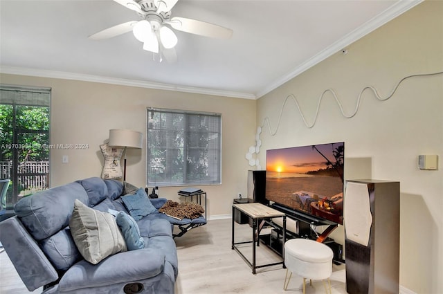 living room featuring light wood-type flooring, ceiling fan, and crown molding