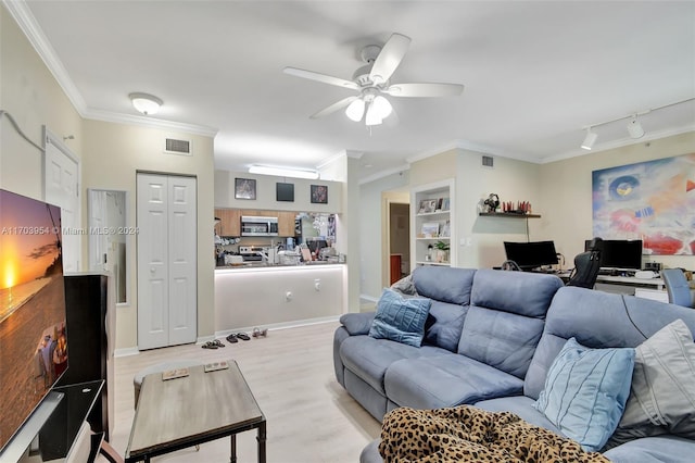 living room with ceiling fan, rail lighting, light hardwood / wood-style floors, and ornamental molding