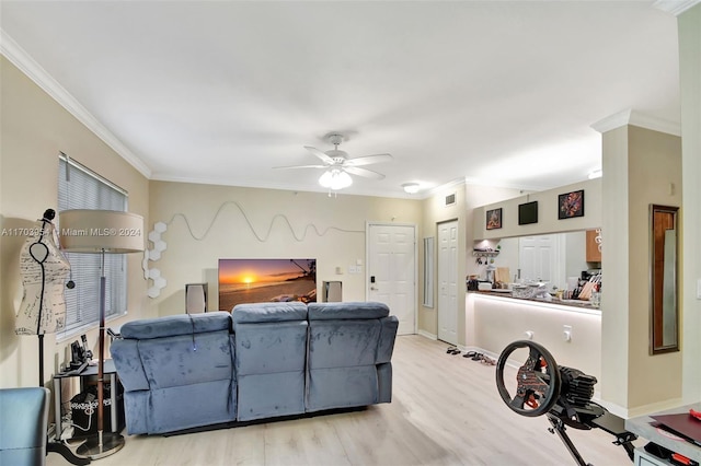 living room featuring light wood-type flooring, ceiling fan, and ornamental molding