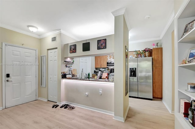 kitchen featuring stainless steel fridge, light hardwood / wood-style floors, and crown molding