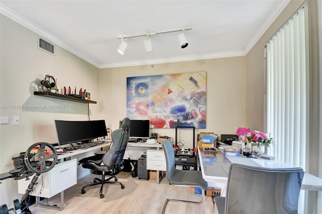 office with light hardwood / wood-style flooring, rail lighting, and ornamental molding