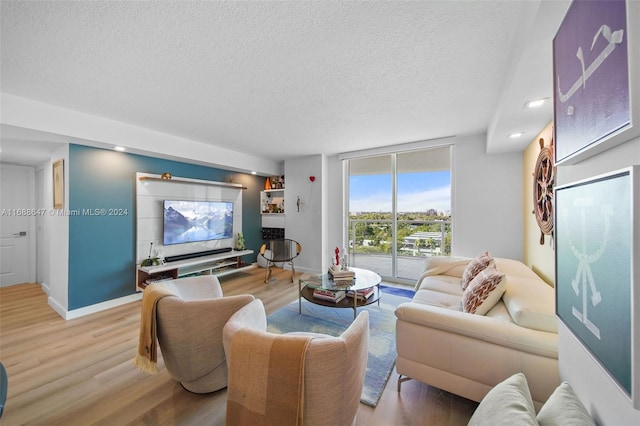 living room featuring hardwood / wood-style flooring and a textured ceiling