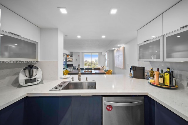 kitchen featuring dishwasher, sink, white cabinets, and blue cabinets