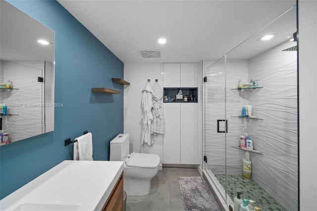 bathroom with a shower with door, vanity, concrete flooring, and toilet