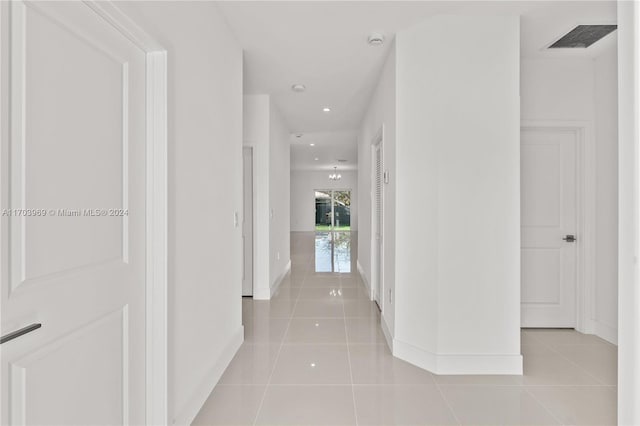 hall with light tile patterned flooring