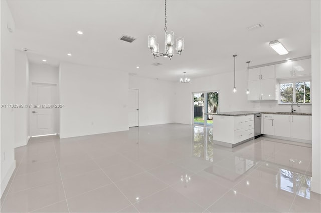 kitchen with pendant lighting, backsplash, stainless steel dishwasher, light tile patterned floors, and white cabinetry