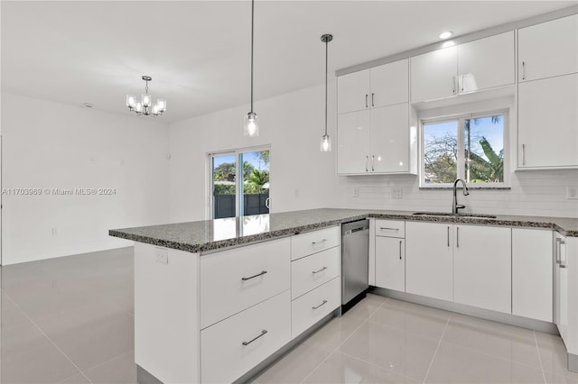 kitchen with white cabinets, dishwasher, hanging light fixtures, and tasteful backsplash