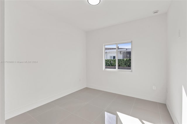 empty room with light tile patterned floors