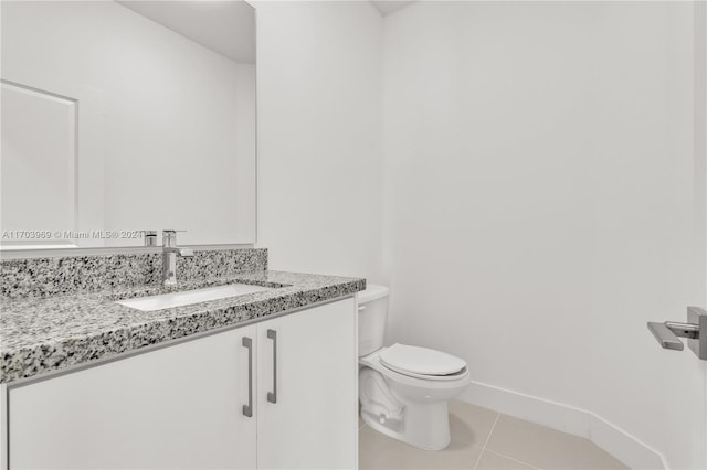 bathroom featuring tile patterned floors, vanity, and toilet