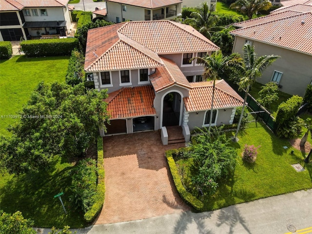 mediterranean / spanish home featuring a front yard