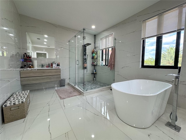 bathroom featuring vanity, separate shower and tub, and tile walls