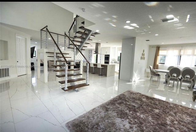 stairway featuring a textured ceiling